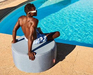 Man on a Pfffh next to a pool
