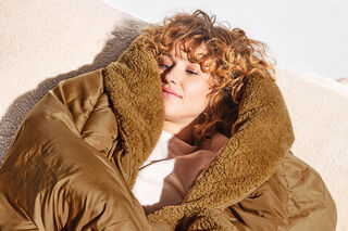 woman under brown hotspot Blanket